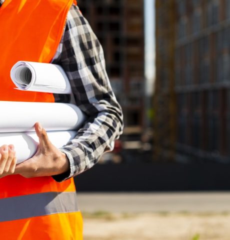 close-up-construction-engineer-holding-plans-hands (Medium)